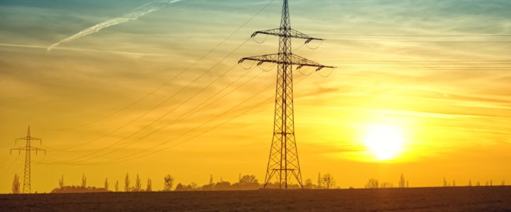 Power lines in front of sunset