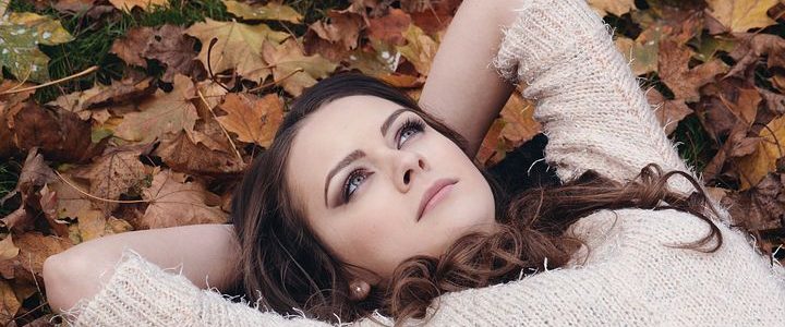 Woman laying on fall leaves