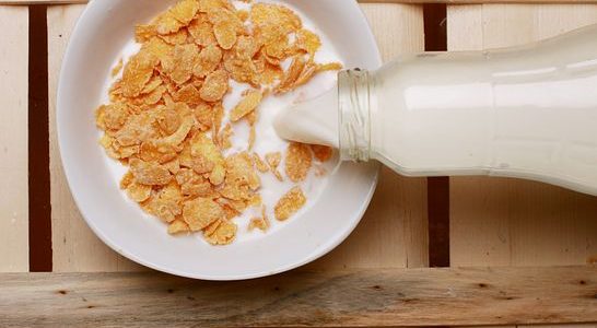 milk being poured on breakfast cereal