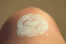 Sunscreen on knee with heart shape engraved into it