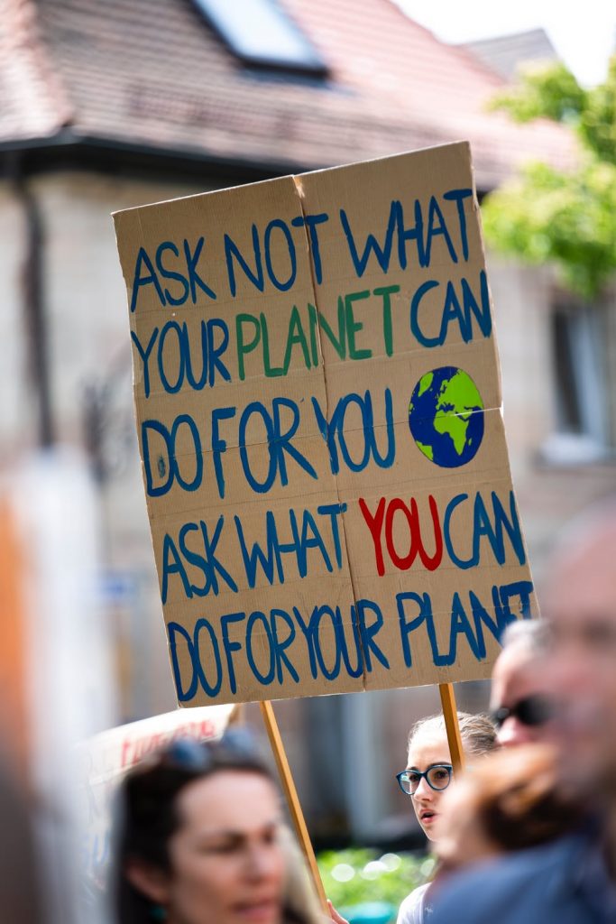 Climate change protester with signs