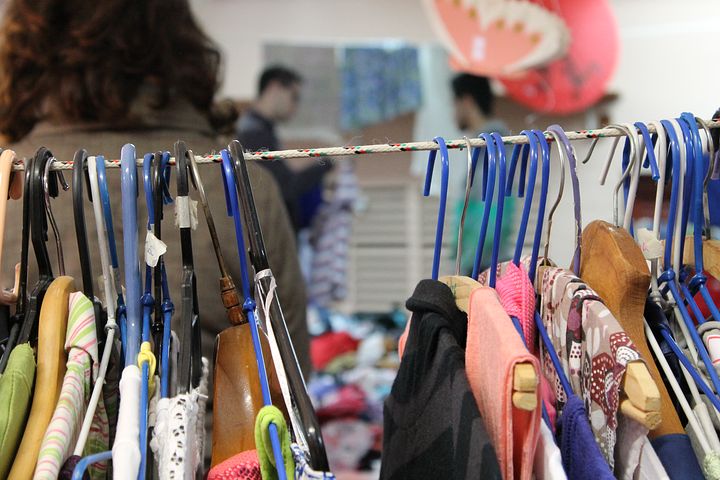 Clothes on rack in thrift shop