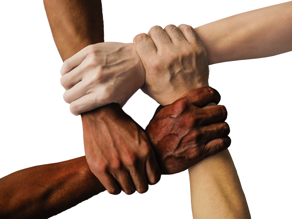 Four hands of different races linked at wrists