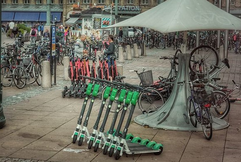 Many scooters and bikes parked