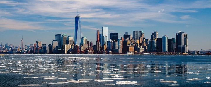 New York City skyline. Sunny day. Ice patches floating in the water.