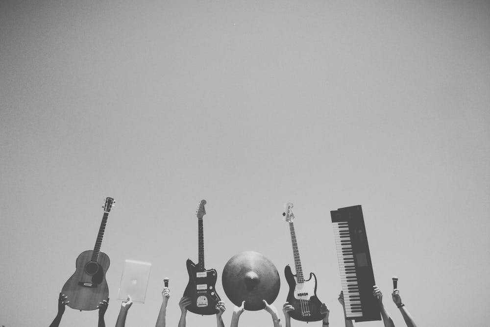 Musical instruments being held above heads