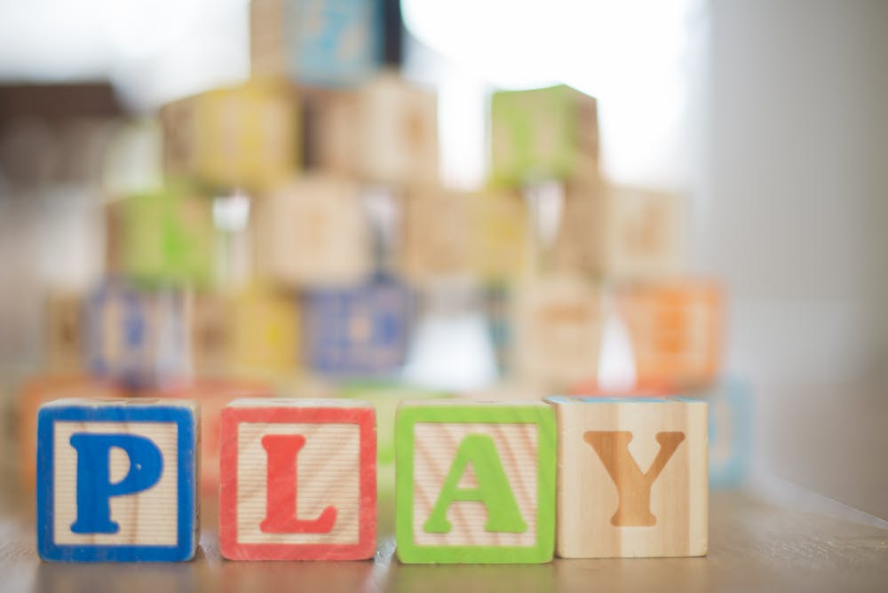 wooden blocks spelling out 'play'
