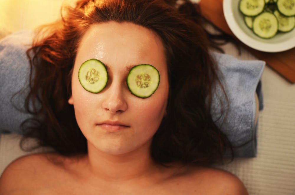 Woman with cucumber on her eyes