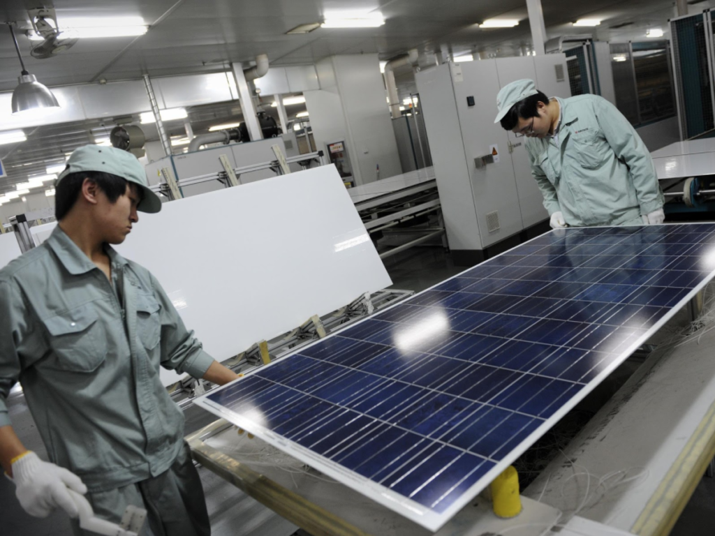 Chinese workers manufacturing solar panels