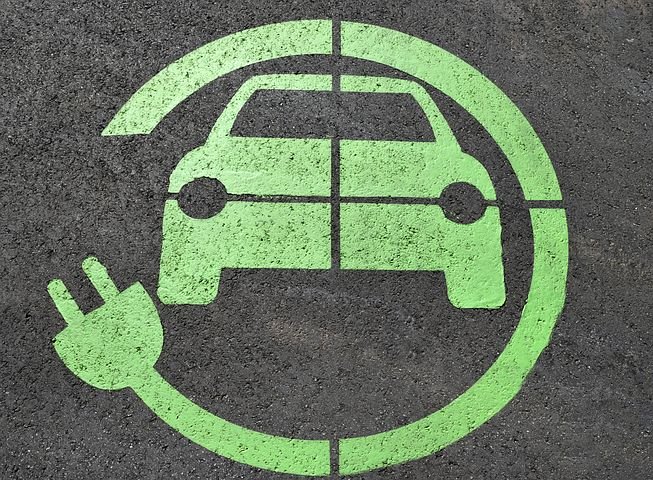 Green electric car charging space markings on road