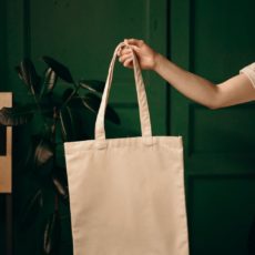Woman holding reusable shopping bag