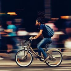 man riding e-bike in the city