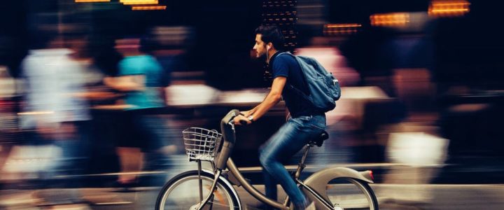man riding e-bike in the city