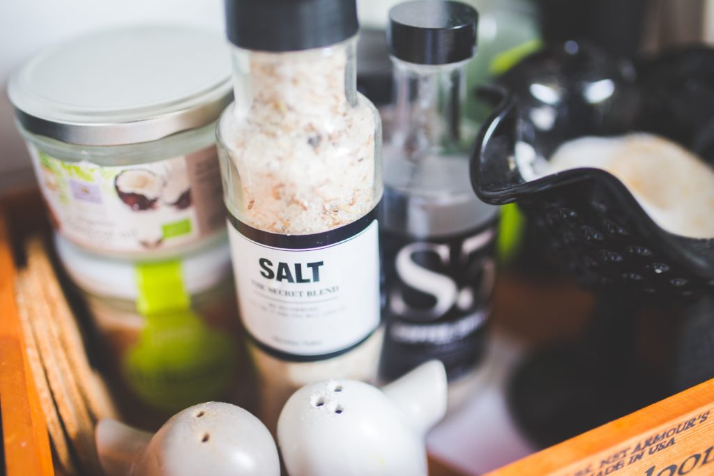 pink rock salt in a bottle and other seasonings