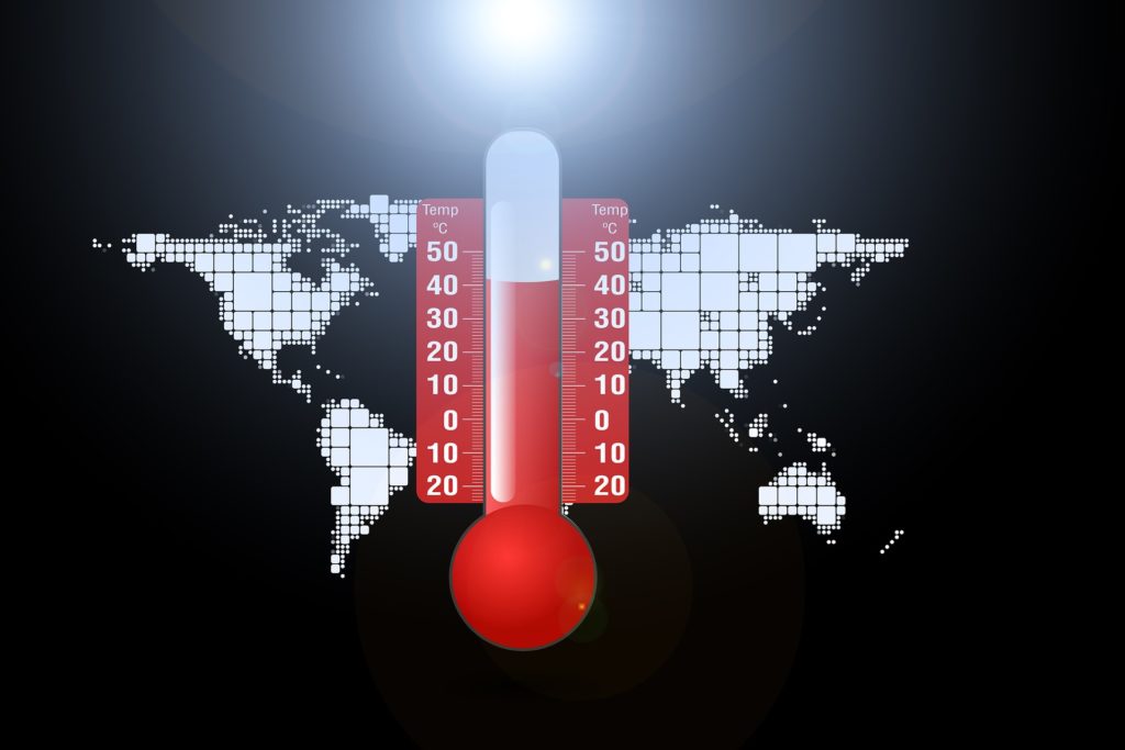 Thermometer with very high temperature over the top of world map
