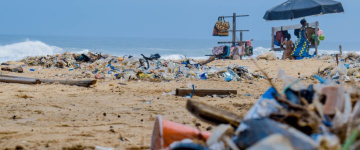 View of beach with close up on plastic trash