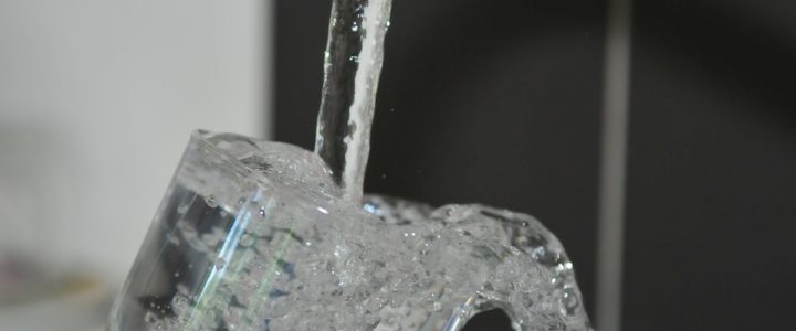 Close up of tap water filling a glass