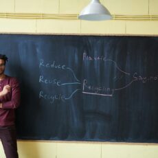 Teacher in front of a chalkboard, with the messaging about the eco R's