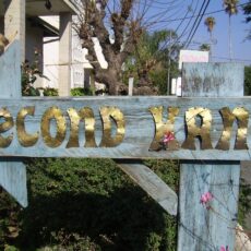 Second hand sign, made with metal on a wooden post